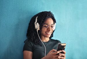woman in black crew neck t shirt wearing white headphones