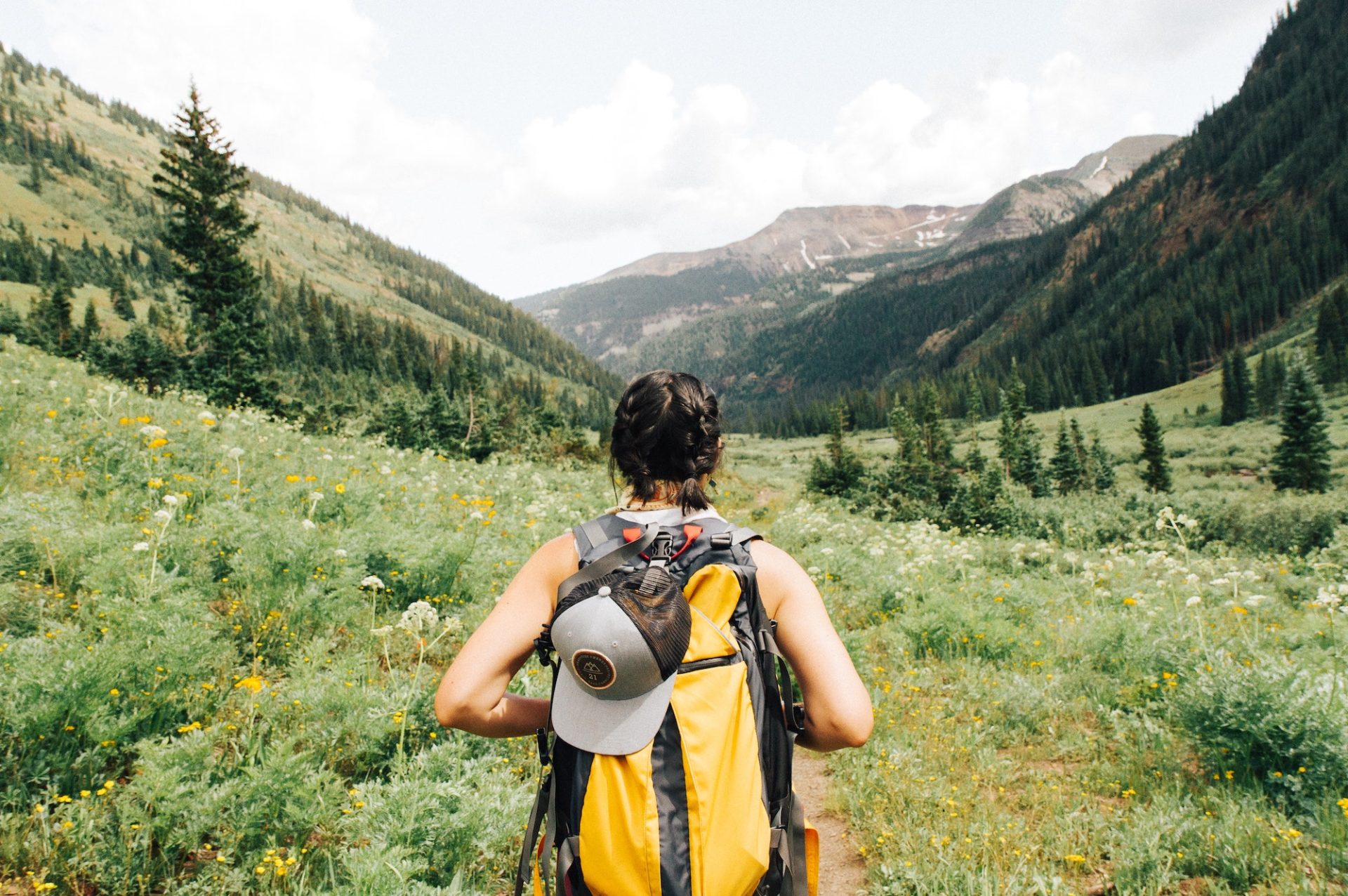 Woman moving forward on a hiking trail.