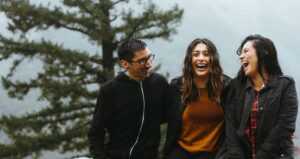 Three people laughing and talking.