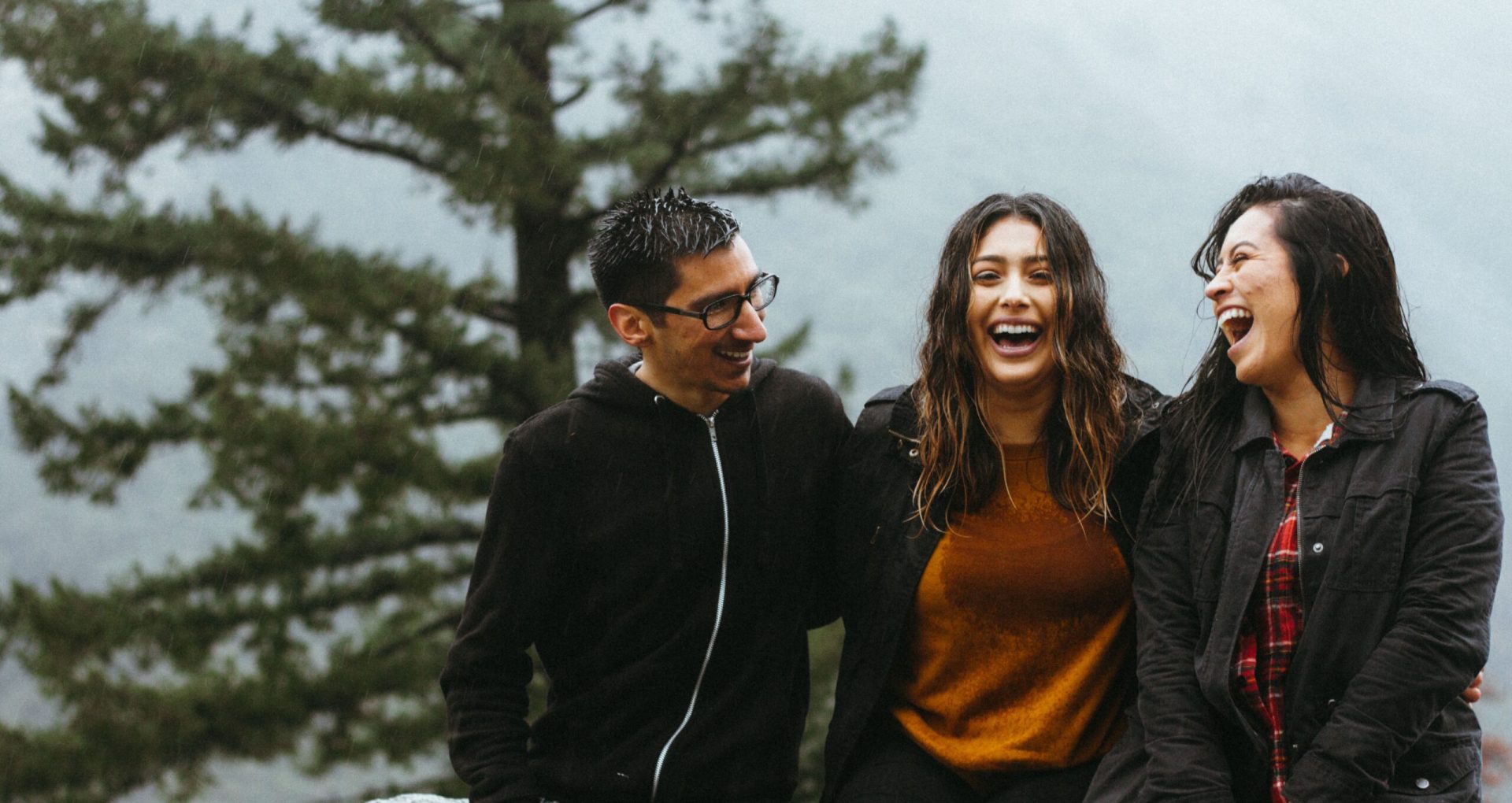 Three people laughing and talking.