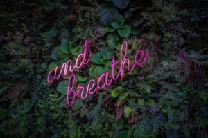 And breathe sign against a plant background.