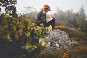 Woman writing in the mountains